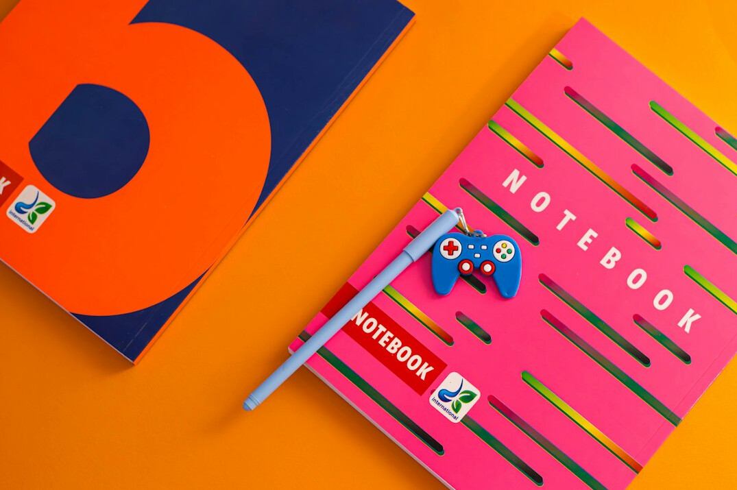 Handwritten notes and a pen on an open notebook on a desk